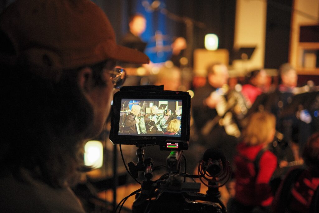 Person filming a performance 