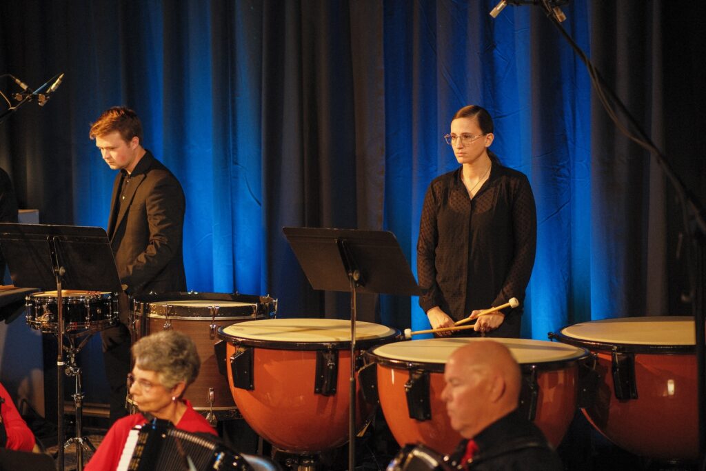 People on stage performing drums at YesWay
